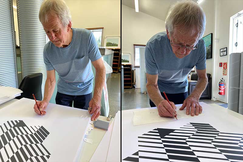 Artist Roy Good signing a geometric screen print on the studio bench